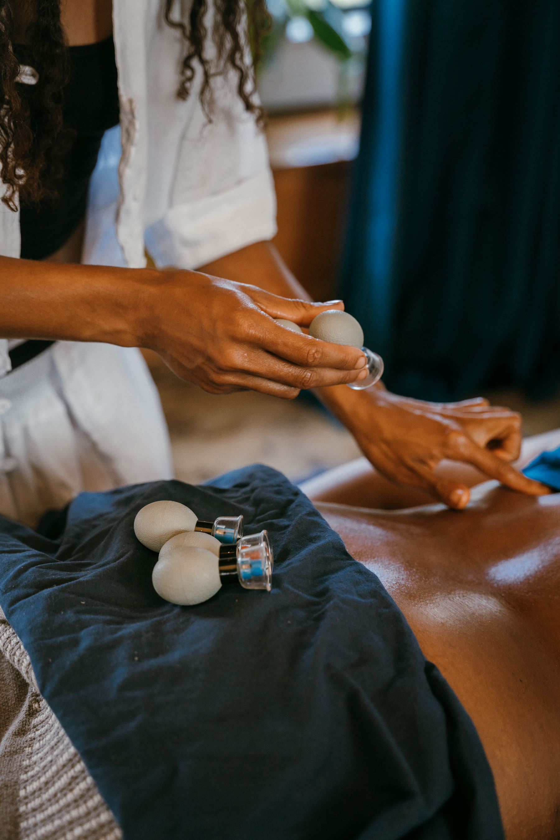 Cupping and bodywork tools resting on a client during a session