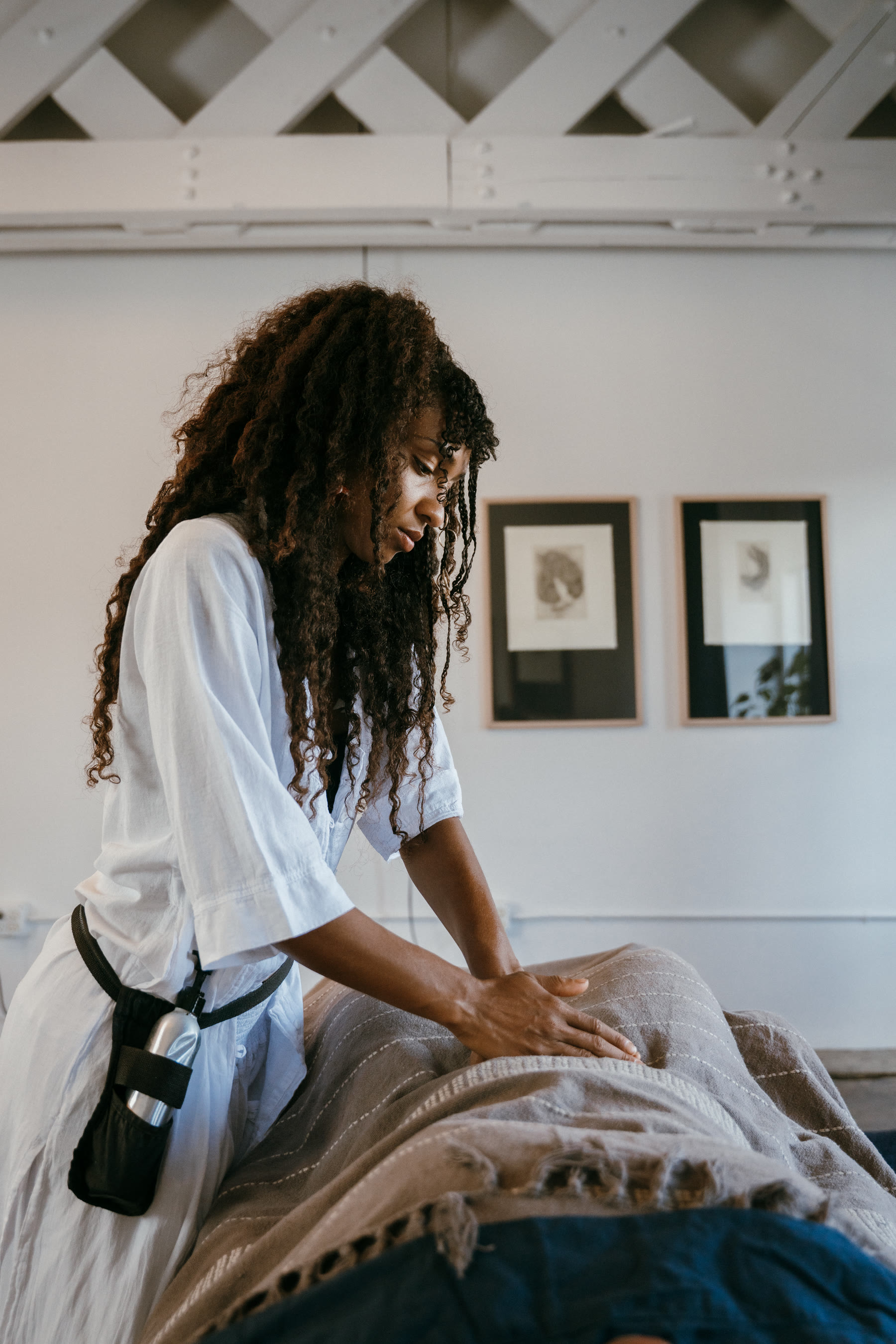 Miryam working over a client on the massage table